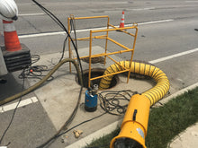 Load image into Gallery viewer, Manhole Sturumi Pump not being used while Site Drainer Pit Boss 102R 1Hp Non clogging Electric submersible dewatering pump and trash pump with Attached Knotted Fireman's Rope is hard at work